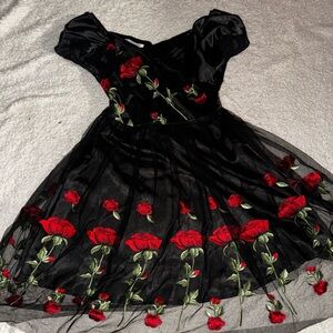 A black flowy dress with embroidered flowers